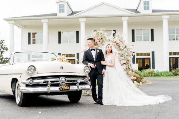 couple with classic car at North Texas wedding venue