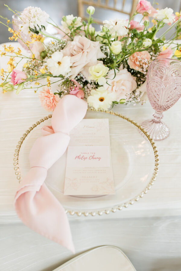 classic romance wedding style place setting with soft pink accents